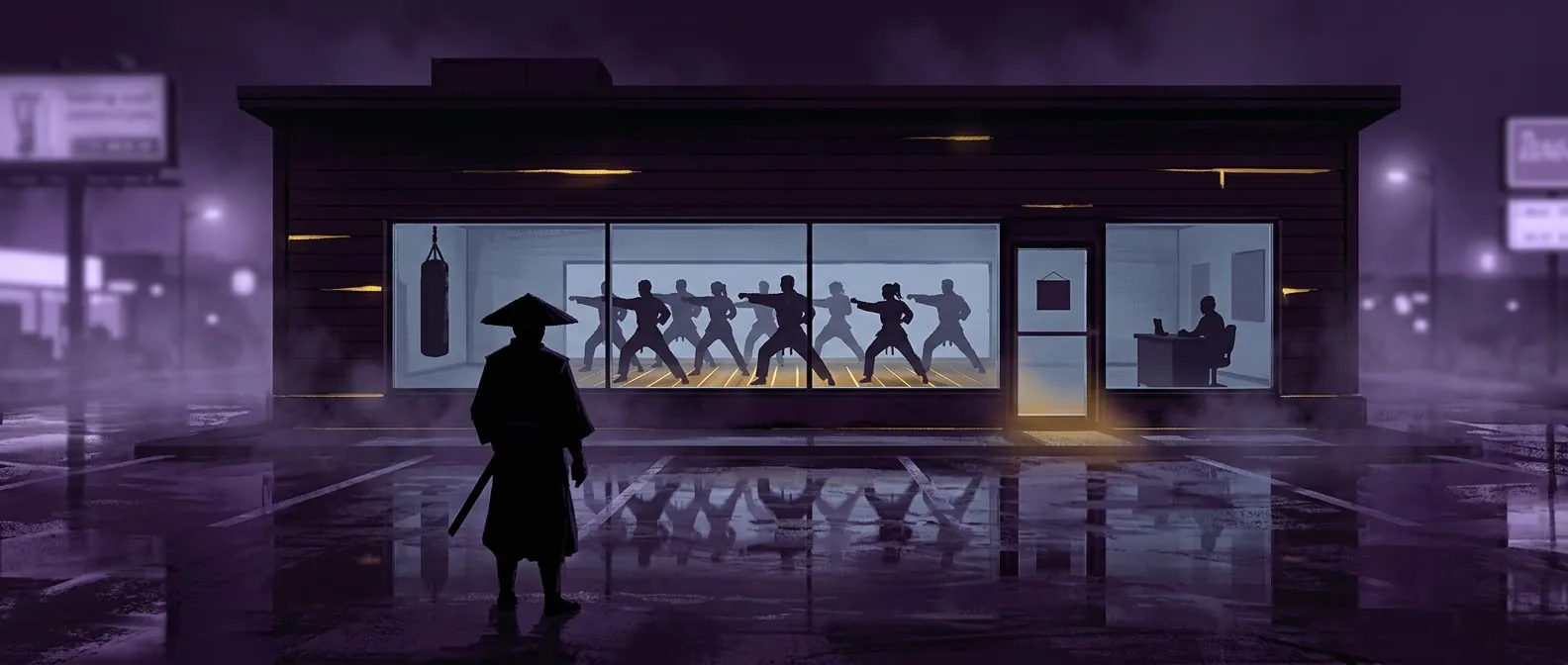 A martial arts school at night — students training in the lit windows while the owner sits alone at a desk in the small office, seen from across a wet parking lot