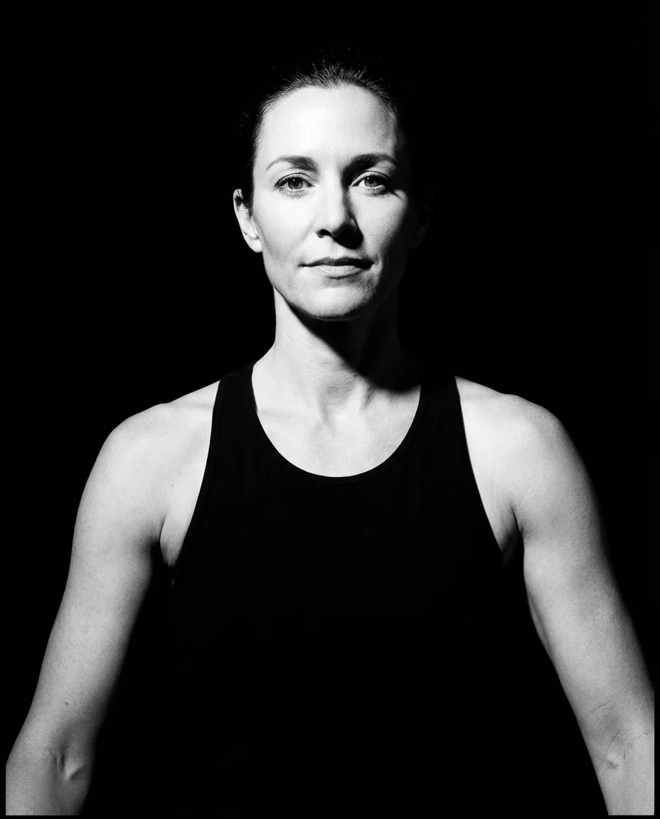 Sarah Mitchell, yoga studio owner in black tank top, professional black and white portrait